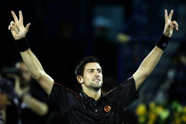 Serbia's Novak Djokovic celebrates after winning the Dubai ATP Open final Tennis match against Swiss Roger Federer on February 26, 2011 in Dubai. Djokovic won 6-3, 6-3.   AFP PHOTO / KARIM SAHIB (Photo credit should read KARIM SAHIB/AFP/Getty Images)