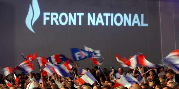 French far-right party members and supporters, wave flags during the National Front's summer convention in Marseille, southern France, Sunday, Sept. 15, 2013. (AP Photo/Claude Paris)