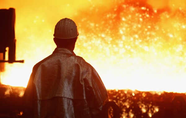 DUISBURG, GERMANY - JANUARY 13:  A worker watches as sparks fly from molten iron heated to approximately 1480 degrees Celsius flowing from a blast furnace at the ThyssenKrupp steelworks on January 13, 2010 in Duisburg, Germany. Recent economic data, including better-than-expected unemployment figures and a positive trend in manufacturing orders in the last quarter, are giving economists hope that the German economy is recovering faster than expected from the effects of the global financial crisis. ThyssenKrupp is Germany's biggest steel producer and is building new mills in Brazil and Alabama.  (Photo by Sean Gallup/Getty Images)